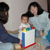 Rachel, Rebecca, and Austin show Maya how to use her presents
